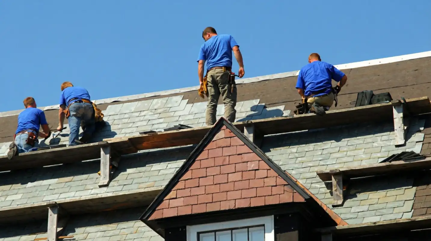 Roof replacement in progress with a team of professional contractors installing new shingles on a residential home in Los Angeles, CA
